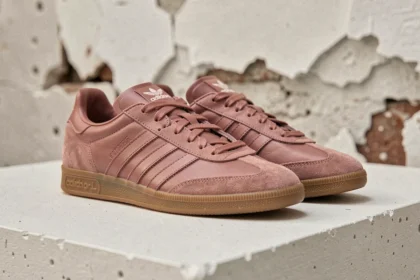 Paire de sneakers Samba rose posée sur une surface en béton blanc, vue de trois quarts mettant en valeur la semelle et le profil de la chaussure